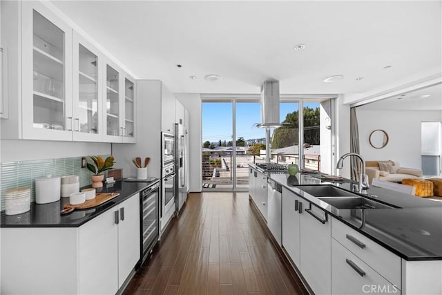 kitchen featuring sink, stainless steel appliances, floor to ceiling windows, wine cooler, and white cabinets