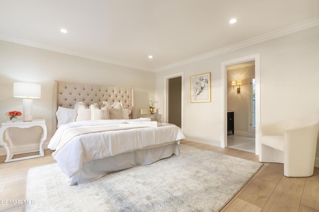 bedroom with crown molding, ensuite bath, and light wood-type flooring