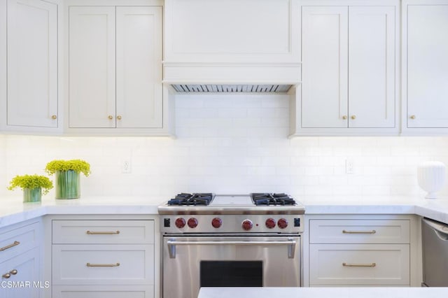 kitchen with tasteful backsplash, white cabinetry, and appliances with stainless steel finishes