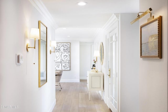 hallway featuring ornamental molding and light hardwood / wood-style flooring