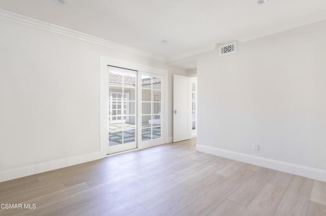 unfurnished room featuring crown molding and light wood-type flooring