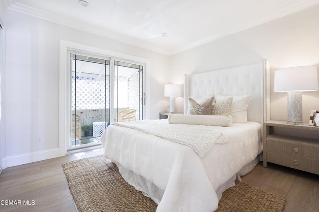 bedroom featuring ornamental molding, access to outside, and light wood-type flooring