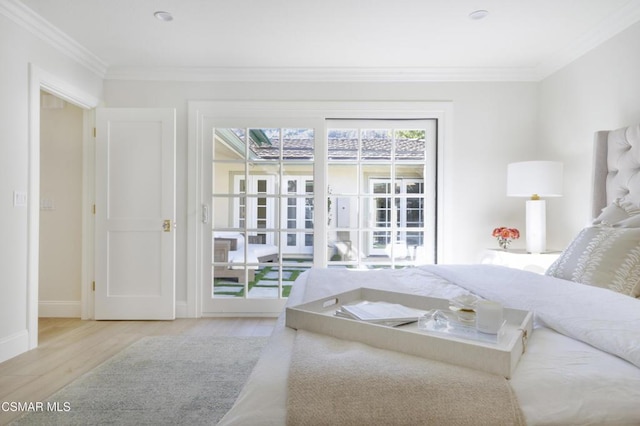 bedroom with ornamental molding and light hardwood / wood-style floors