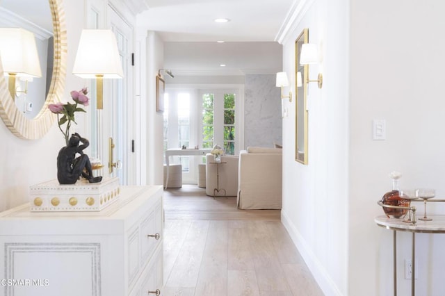 hall featuring crown molding and light wood-type flooring