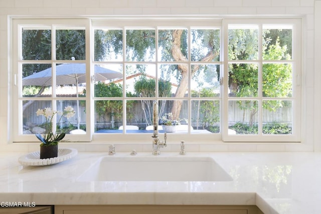 room details with light stone counters and sink