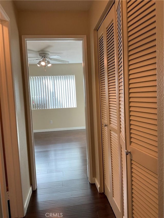 7405 Charmant Dr Unit 2320, San Diego, CA 92122 - corridor with baseboards and dark wood-type flooring
