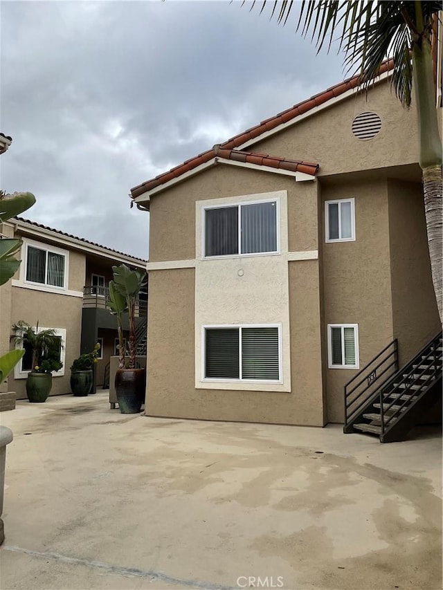7405 Charmant Dr Unit 2320, San Diego, CA 92122 - view of side of home featuring stucco siding and a patio area