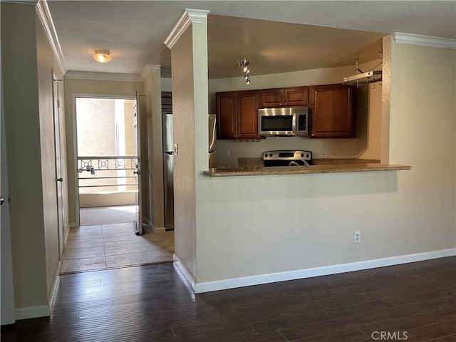 7405 Charmant Dr Unit 2320, San Diego, CA 92122 - kitchen featuring appliances with stainless steel finishes, ornamental molding, dark wood-style floors, baseboards, and brown cabinets
