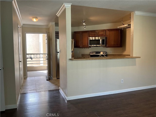 7405 Charmant Dr Unit 2320, San Diego, CA 92122 - kitchen featuring stainless steel microwave, range, ornamental molding, dark wood-type flooring, and brown cabinets