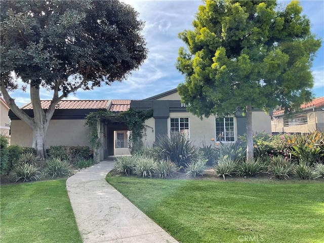 7405 Charmant Dr Unit 2320, San Diego, CA 92122 - view of front of property with a front lawn, stucco siding, and a tile roof