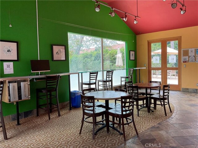 7405 Charmant Dr Unit 2320, San Diego, CA 92122 - dining space with track lighting, lofted ceiling, and stone tile floors