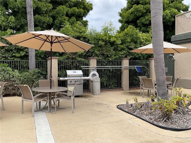 7405 Charmant Dr Unit 2320, San Diego, CA 92122 - view of patio / terrace with outdoor dining space, a grill, and fence