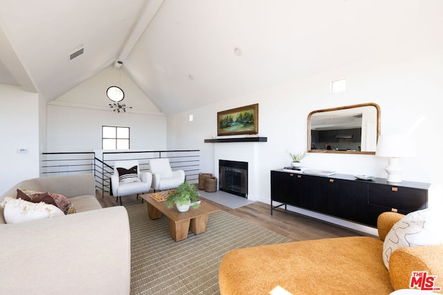 living room featuring beam ceiling, high vaulted ceiling, and light wood-type flooring