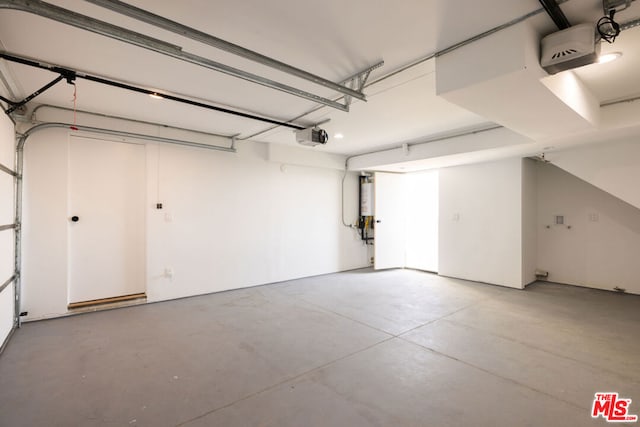 garage with a garage door opener and water heater