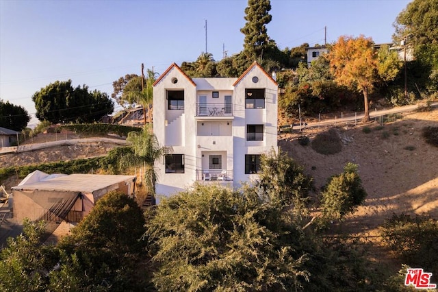 rear view of property featuring a balcony