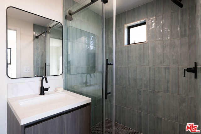 bathroom with vanity and a shower with shower door