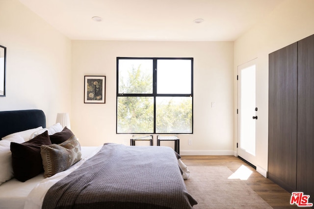 bedroom with light hardwood / wood-style flooring