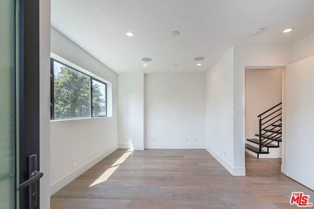 spare room with light hardwood / wood-style floors