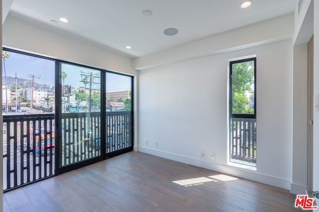 spare room with hardwood / wood-style floors