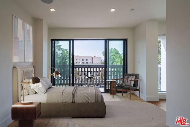 bedroom featuring access to exterior and light hardwood / wood-style floors