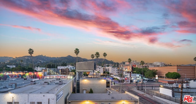 property's view of city with a mountain view