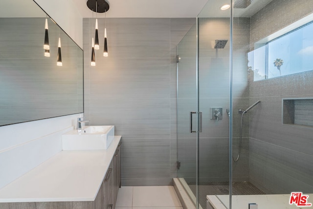 bathroom featuring vanity, tile patterned floors, and walk in shower