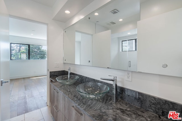 bathroom with vanity and hardwood / wood-style flooring