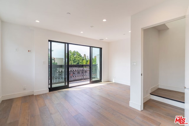 spare room with light hardwood / wood-style flooring