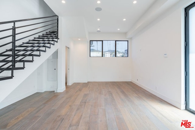 unfurnished living room with hardwood / wood-style flooring