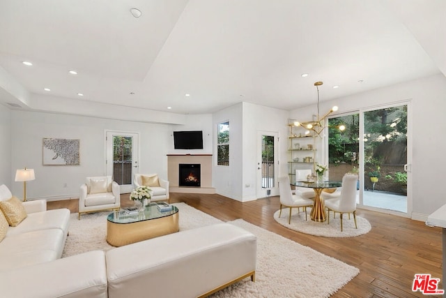 living room featuring hardwood / wood-style flooring, a chandelier, and a wealth of natural light