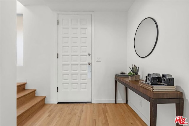 foyer entrance with hardwood / wood-style flooring