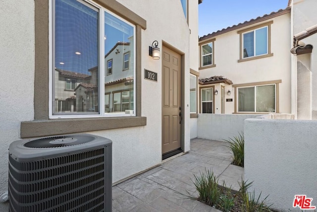 entrance to property featuring cooling unit