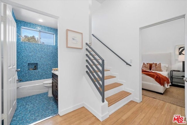 staircase featuring hardwood / wood-style flooring