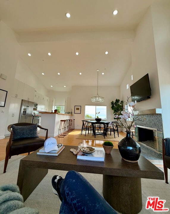 living room with a high ceiling and light wood-type flooring