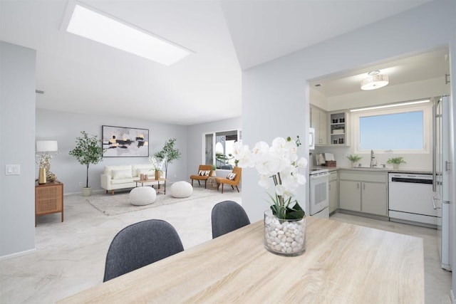 dining space with sink and a skylight