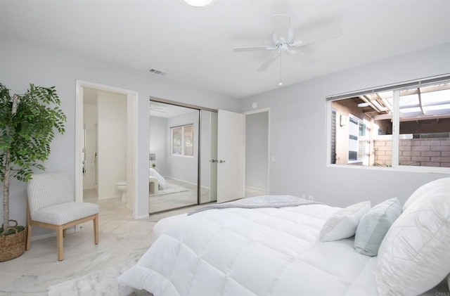 bedroom featuring a ceiling fan, a closet, visible vents, and ensuite bathroom