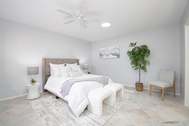 bedroom featuring ceiling fan and baseboards