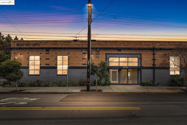 view of outdoor building at dusk