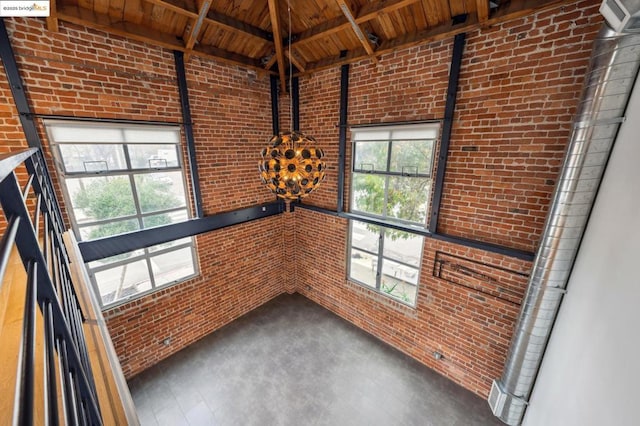 interior space with beamed ceiling, a healthy amount of sunlight, and wood ceiling