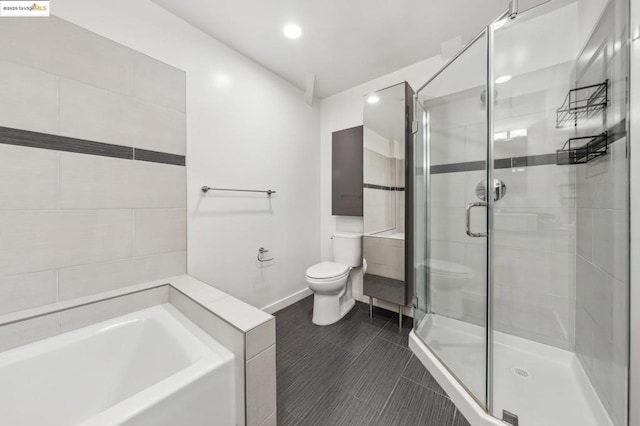 bathroom featuring toilet and separate shower and tub