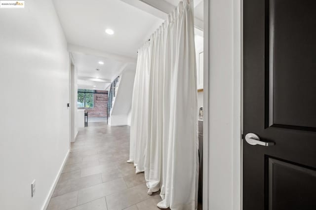 hallway with light tile patterned floors