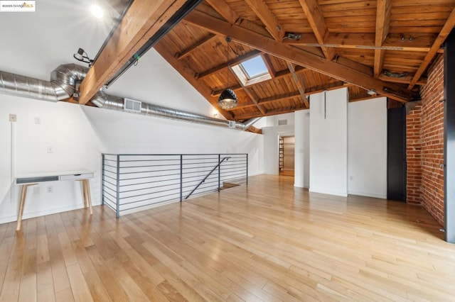 unfurnished room featuring wood ceiling, a skylight, high vaulted ceiling, beamed ceiling, and light hardwood / wood-style floors