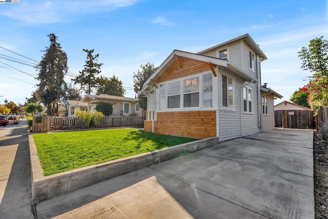 view of front of house with a patio and a front lawn