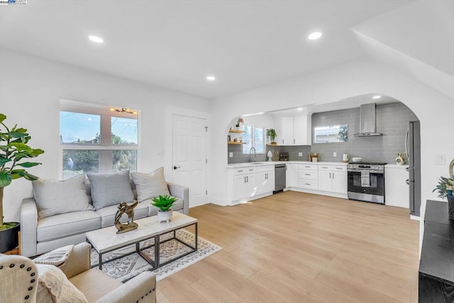 living room with sink and light hardwood / wood-style flooring