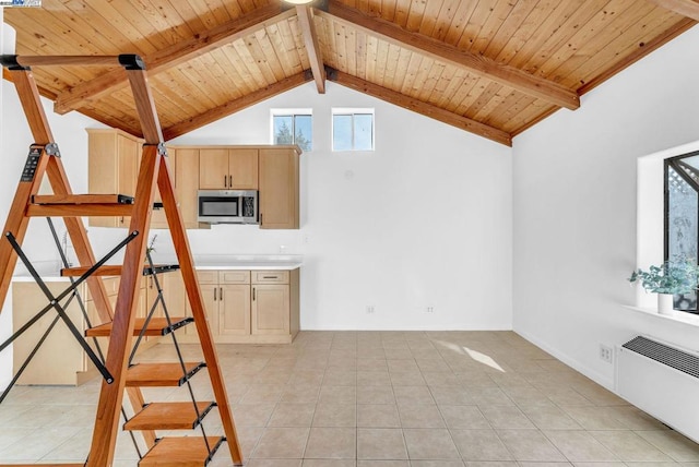 interior space with radiator heating unit, beam ceiling, light tile patterned floors, and wooden ceiling