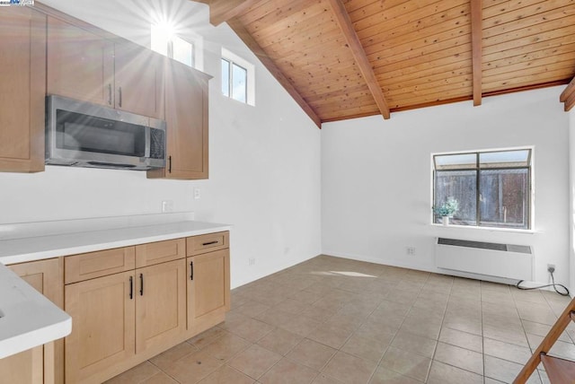 kitchen featuring wood ceiling, beam ceiling, radiator, and light brown cabinetry