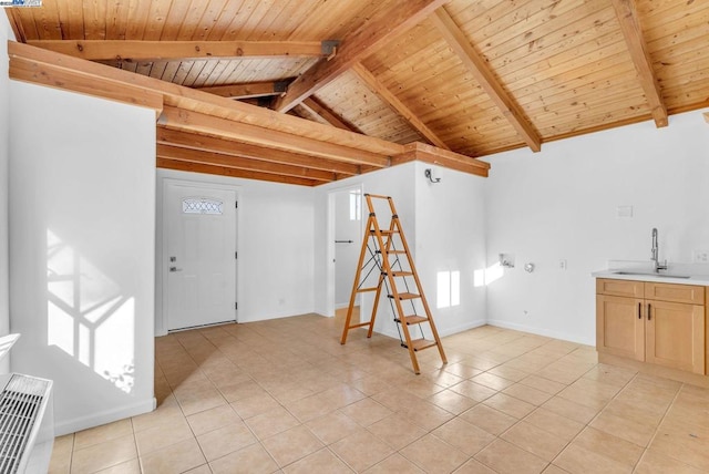 interior space with light tile patterned flooring, sink, and wood ceiling