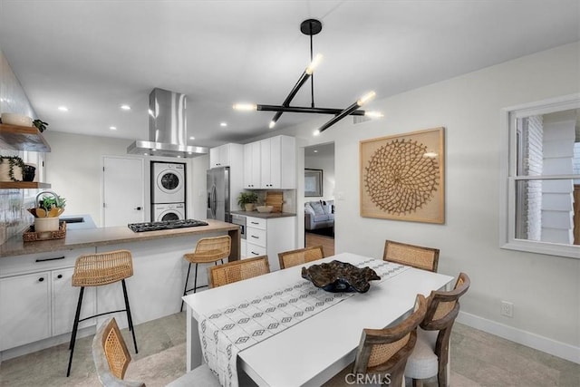 dining room with stacked washer and clothes dryer