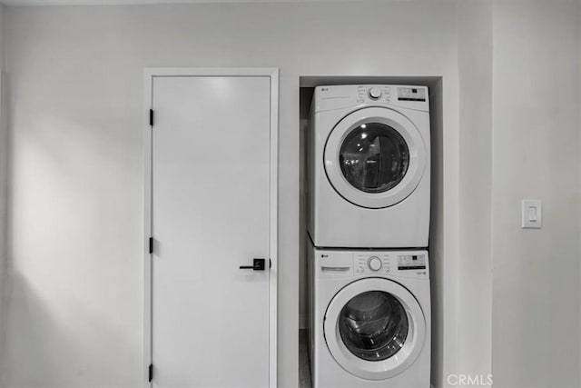 laundry area with stacked washer and dryer