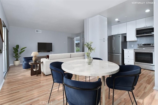 dining area with light hardwood / wood-style floors